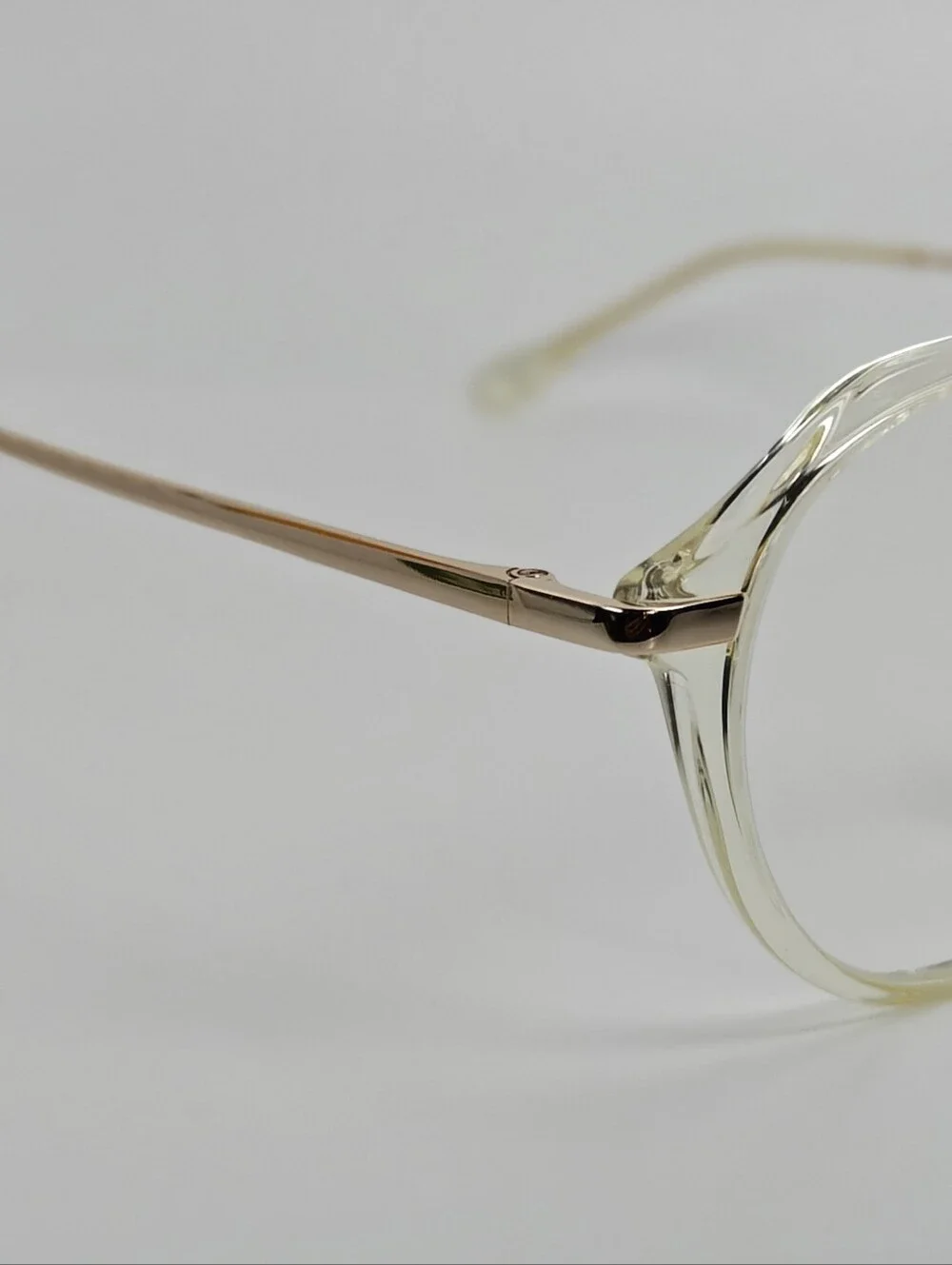 Tamara. Clear Round Frame Glasses. All Gold Accents are Metal.